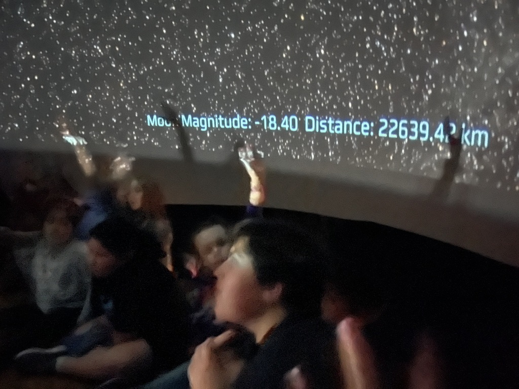 students inside planetarium